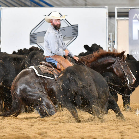 Scott Amos, cutting horse trainer riding in NCHA event